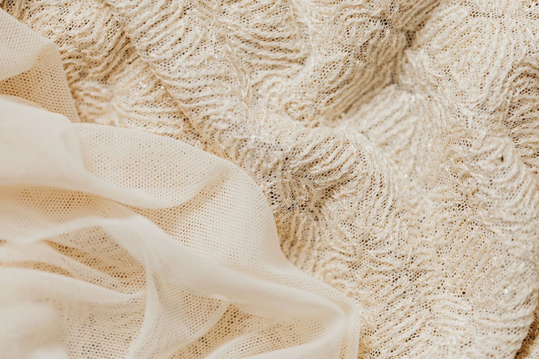 Close detail of layered lace and sheer textile.